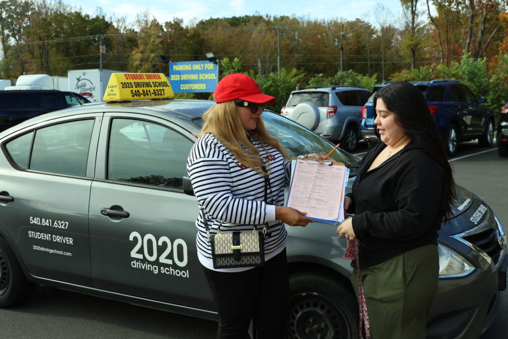 Instructor reviewing progress with a student at 2020 Driving School