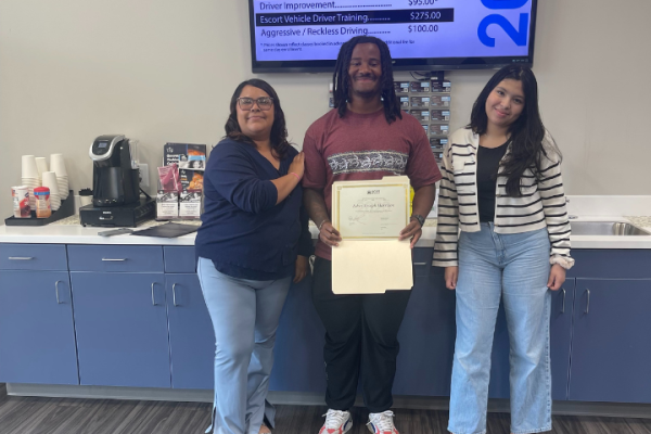 Students proudly holding completion certificate at 2020 Driving School